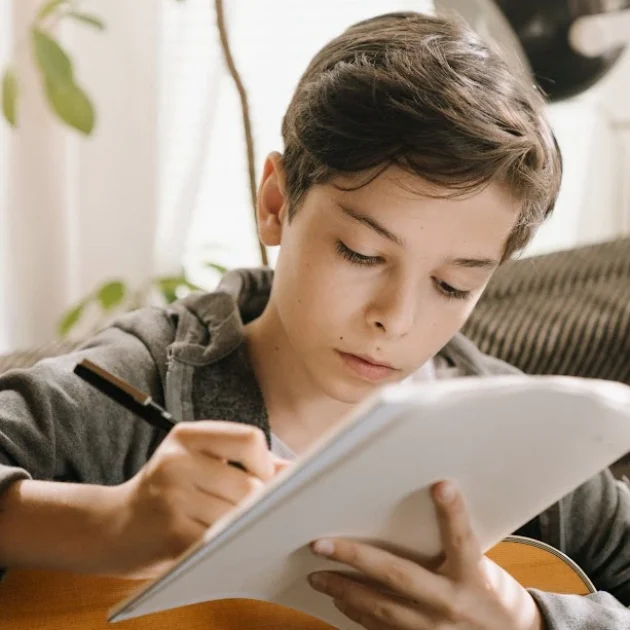 boy with guitar and paper